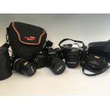 Two cameras, Olympus OS10 and Minolta X-370s, together with Olympus flash and lens, all in cases.