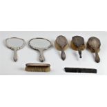 A collection of hallmarked silver dressing table sets, to include three hair brushes, two hand