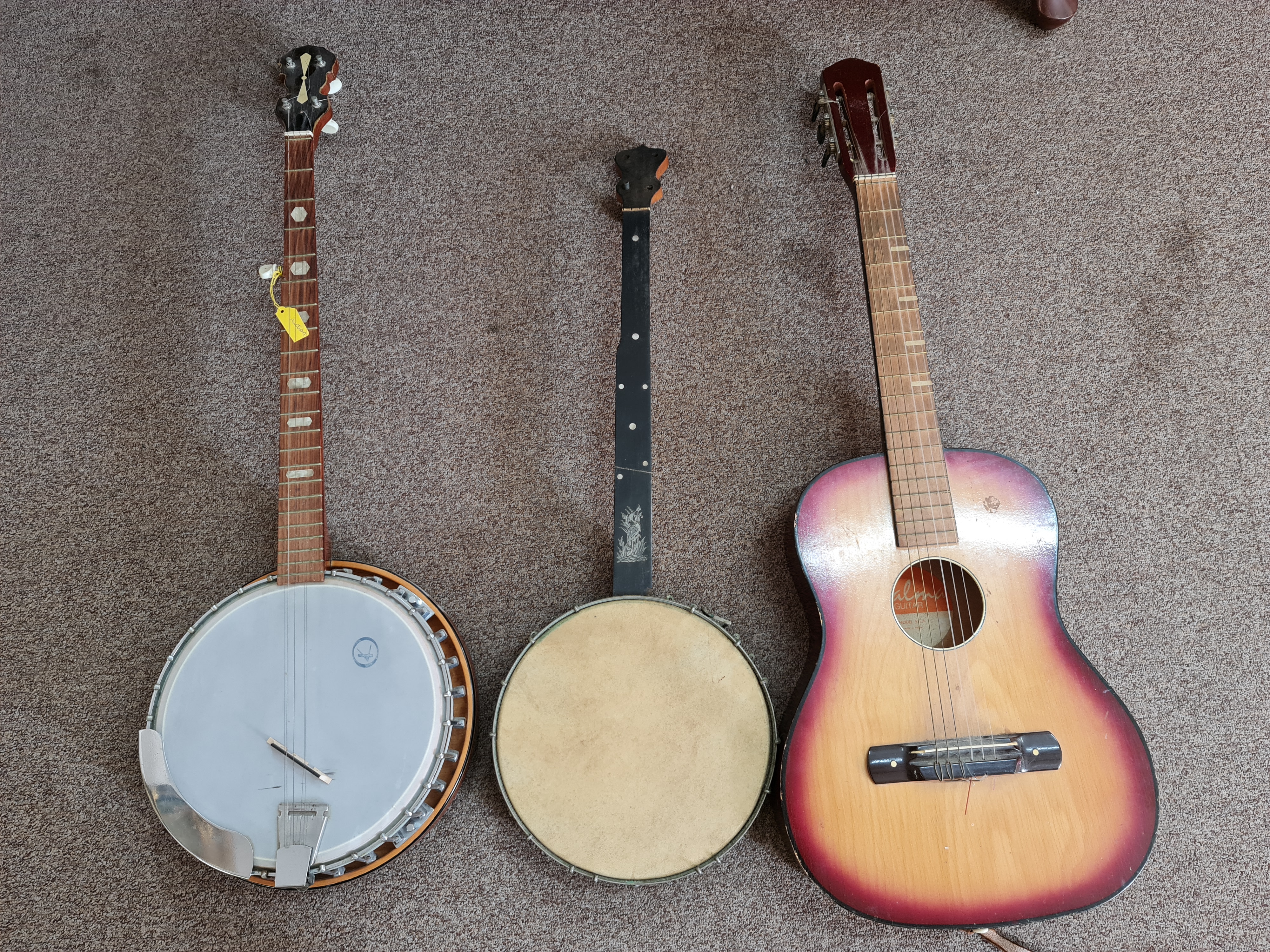 Two various banjos, one in case, with a Spanish guitar, in case. IMPORTANT: Online viewing and