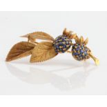 A sapphire set berry and leaf design brooch, stamped 750, length approx. 5cm weight approx. 8.6g.