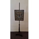 A rosewood Victorian firescreen pole with tapestry glazed panel. IMPORTANT: Online viewing and