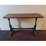 A Mitchell’s & Butlers Ltd cast iron based pub table with original wooden top and an alternative