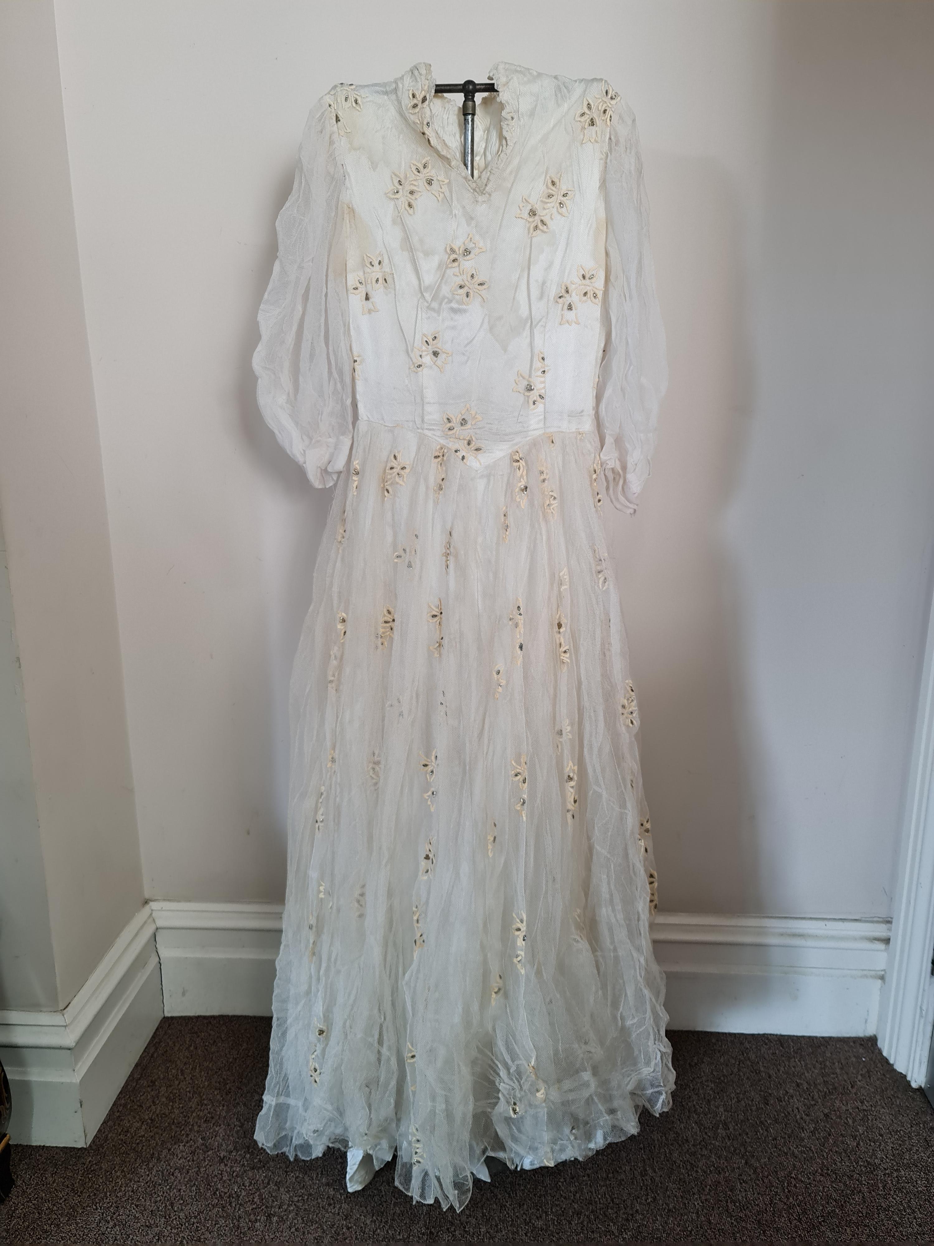 A 1950s lace wedding dress with veil. IMPORTANT: Online viewing and bidding only. No in person