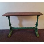 A Mitchell’s & Butlers Ltd cast iron based pub table with original wooden top and an alternative