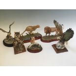 Four Border Fine Arts animal figures to include lion, owl and cheetah, with two Capodimonte bird