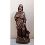 One piece wooden 19th century church carving of Saint Roch, patron Saint of dogs, with dog at