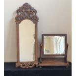 A Victorian mahogany swing mirror together with a walnut carved wall mirror.