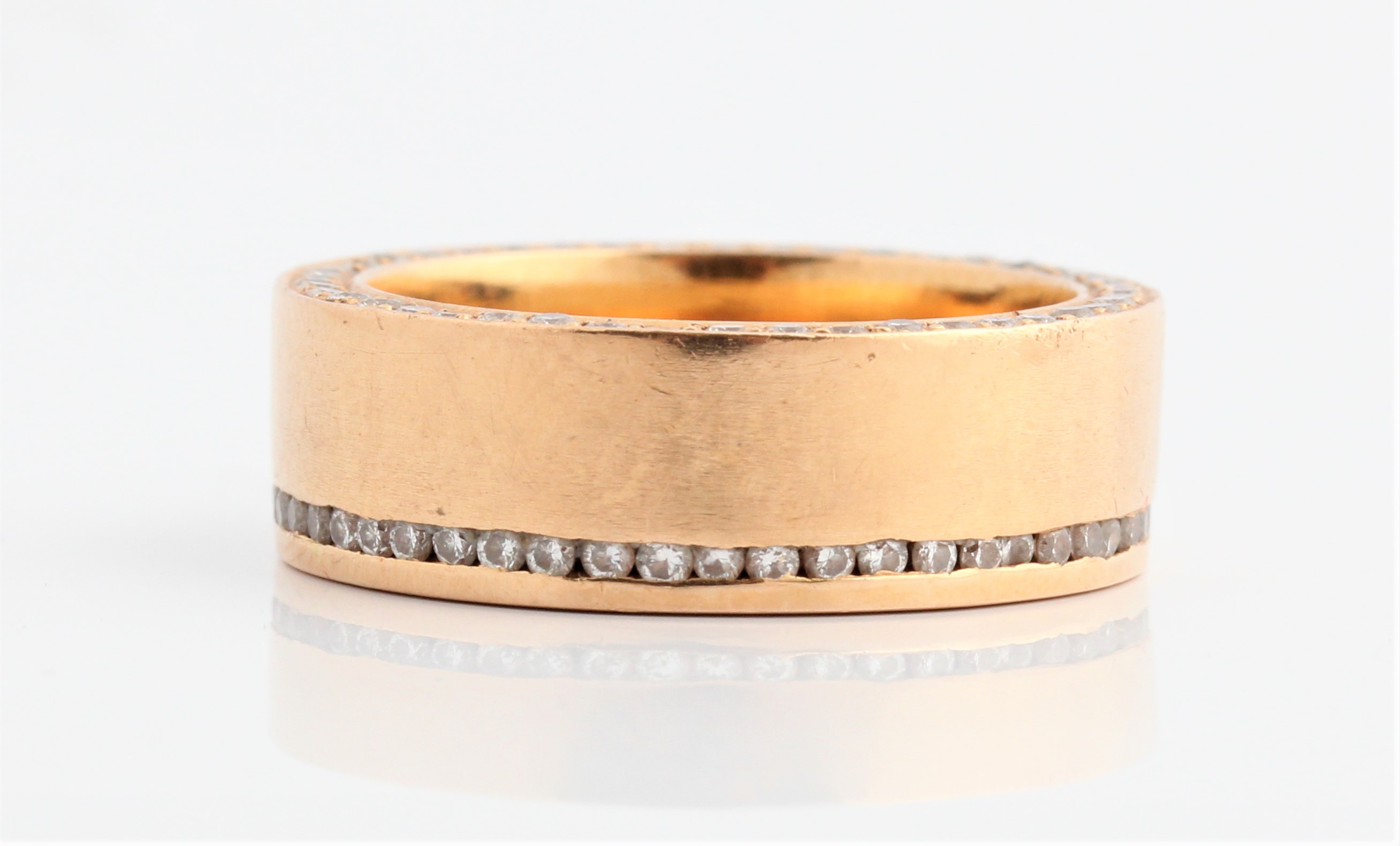 A diamond set wedding band, channel set with round brilliant cut diamonds to top of band and