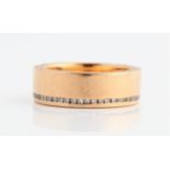 A diamond set wedding band, channel set with round brilliant cut diamonds to top of band and