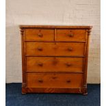 A mahogany Victorian chest with three long and two short drawers, with turned column sides.