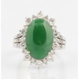 A jade and diamond cluster ring, set centrally with an oval jadeite jade cabochon, measuring approx.