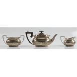 A hallmarked silver three piece tea set, comprising a tea pot, a sugar bowl and a milk jug, all with