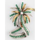An emerald and diamond palm tree design pendant, set with a principal round brilliant cut diamond