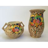 A Crown Ducal bulbous two-handled vase and a taller vase decorated with multi-coloured clusters on