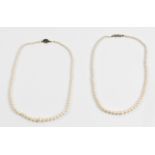 Two single row cultured pearl necklaces, one with diamond accent set clasp stamped 9ct, the other