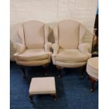 A pair of cream upholstered wing back fireside chairs and two cream upholstered stools. IMPORTANT:
