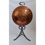 An arts and crafts copper fire screen on cast iron tripod base with dragon design. IMPORTANT: