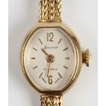 A hallmarked 9ct yellow gold cased ladies Accurist wristwatch, the white dial having hourly baton