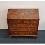 A mahogany Georgian bureau fitted with three long and two short drawers, and fitted interior.