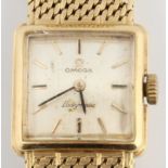 A hallmarked 18ct yellow gold cased ladies Omega Ladymatic wrist watch, the square dial having