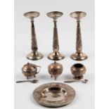 A collection of white metal items, to include three flute bud vases, approx. height 15cm, together