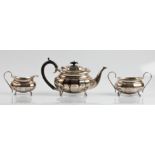 A Viners hallmarked silver three piece tea set, comprising a tea pot, a sugar bowl and a milk jug.