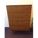 A mid 20th century five drawer chest with brass finished narrow handles, 103cm x 68.5cm x 46cm.