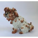 A Meissen Bolognese dog, marked with crossed swords to base, height 22cm.