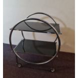 A chrome and black glass Art Deco style two tier tea trolley. IMPORTANT: Online viewing and