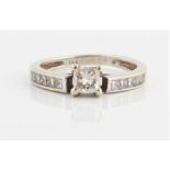 A diamond ring, set with a principal princess cut diamond, measuring approx. 0.40ct, with further