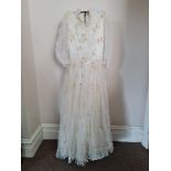 A 1950s lace wedding dress with veil. IMPORTANT: Online viewing and bidding only. No in person