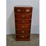 A reproduction metal bound campaign narrow chest with a three draw matching chest of drawers