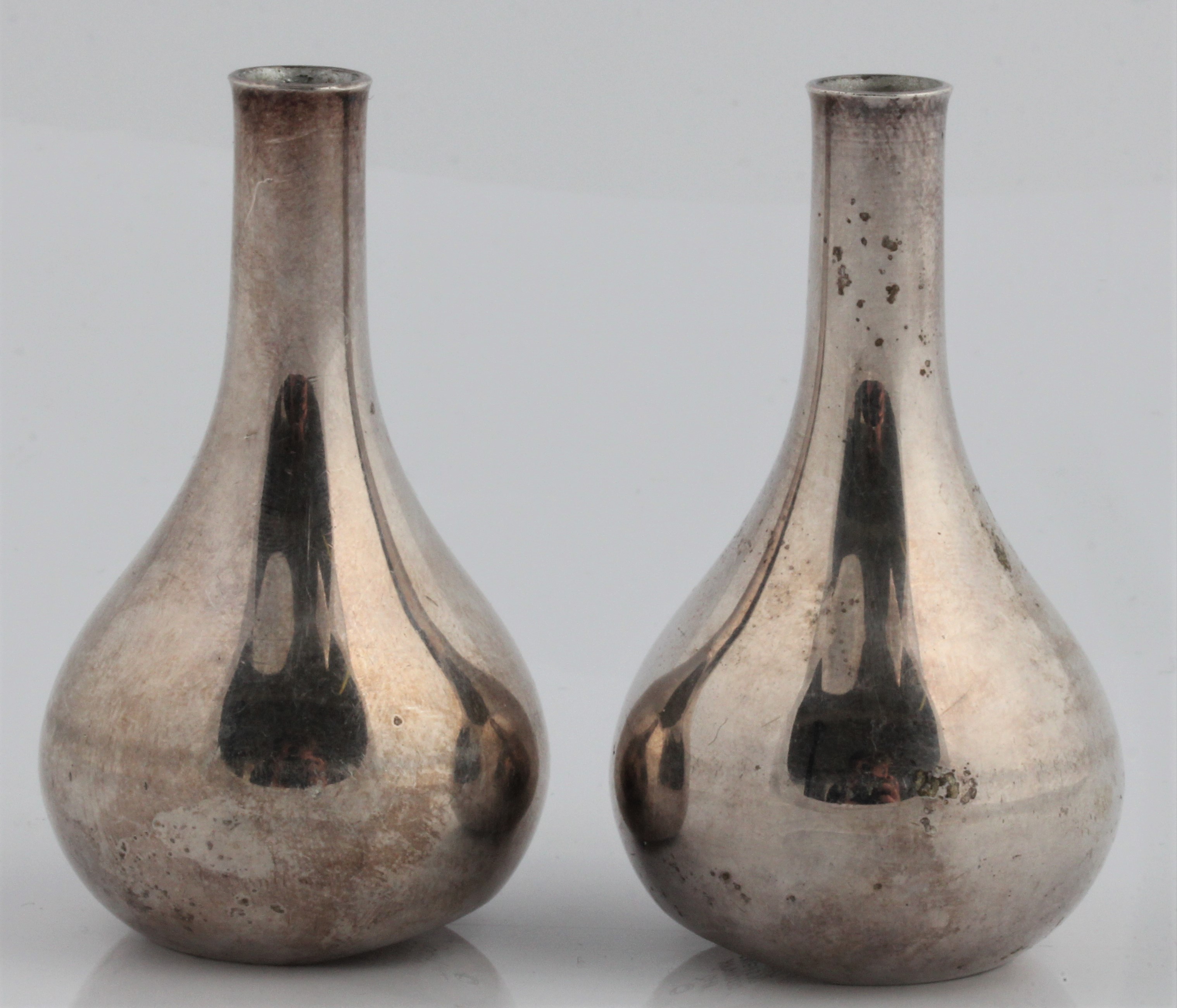 A pair of Jens Quistgaard for Dansk Designs weighted taper stick or candle holders, marked DANSK.