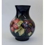 A Moorcroft Clematis pattern vase, signed to base, approx height 25cm. IMPORTANT: Online viewing and