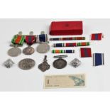 A collection of medals, a trio including 'FOR EXEMPLARY POLICE SERVICE', 'CROWNED 2ND JUNE 1953
