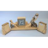 An Odyv Art Deco mantel clock with girls playing catch, height 25cm, together with two matching