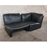 A mid 20th century black leather upholstered two piece sofa suite. IMPORTANT: Online viewing and