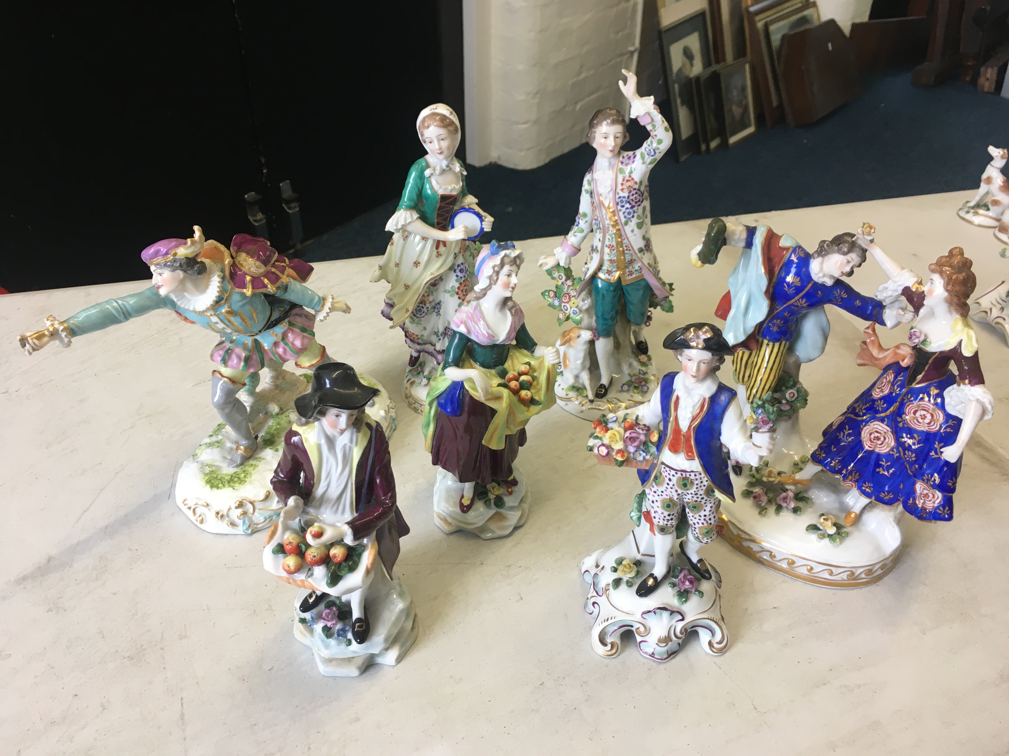 Seven Meissen style figures and figure groups, courting couple dancing, men holding fruit, man