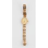 A ladies Accurist wrist watch, case stamped 375, on a hallmarked 9ct yellow gold open metalwork