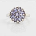 A tanzanite and diamond cluster ring, stamped 9k, ring size M.