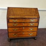 A Georgian oak four drawer bureau with part fitted interior. IMPORTANT: Online viewing and bidding