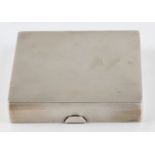 A silver rectangular machined cigarette box, hallmarked Birmingham 1932, measures approx. 8x9cm.