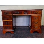 A mahogany reproduction leather insert desk together with four drawer filing cabinet. IMPORTANT: