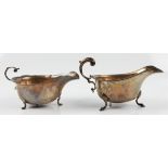 Two hallmarked silver sauce boats, both having scroll handles and raised on three hoof feet. BOOK