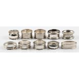 A collection of ten various hallmarked silver napkin rings, each of differing design and date.