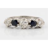 A hallmarked platinum sapphire and diamond five stone ring, set with three graduated round brilliant