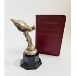 A 20th century Rolls Royce Spirit of Ecstasy car mascot and owners book. IMPORTANT: Online viewing