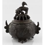 A Chinese bronze lidded censer topped with foo dog with figures to centre, approx. height 9.5cm.