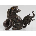 A Chinese bronze foo dog with ball under paw, approx. height 14cm. IMPORTANT: Viewing is available