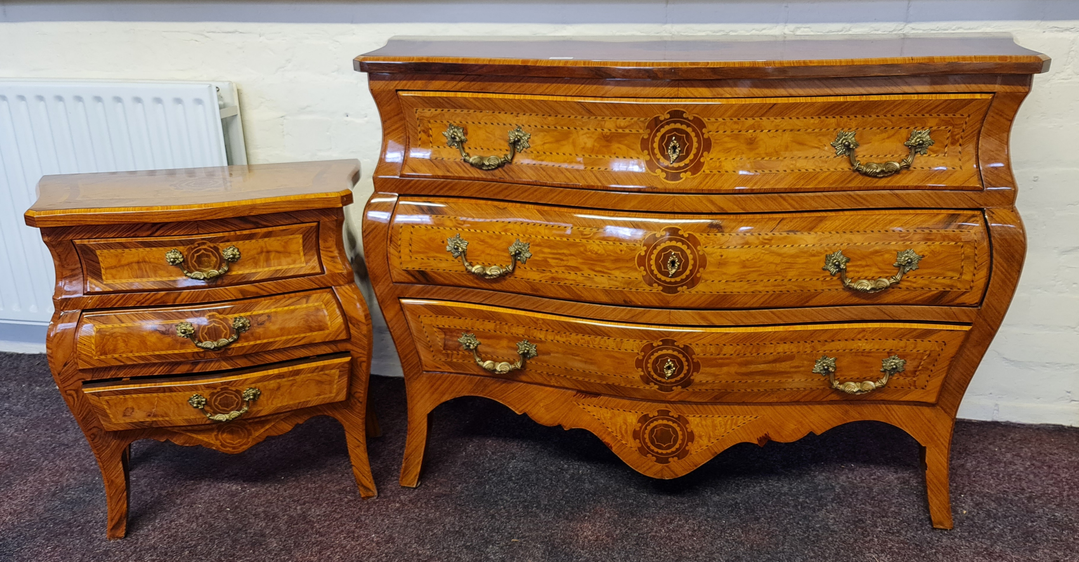 A reproduction king wood and walnut style French three drawer chest with two matching bedside